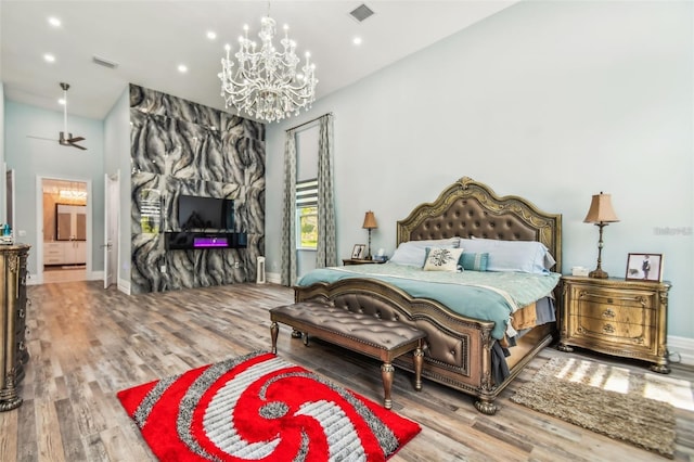 15715 Trousdale St, Clermont, FL 34715 - bedroom with a chandelier, wood finished floors, recessed lighting, and vaulted ceiling