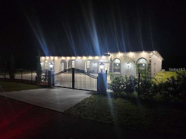 15715 Trousdale St, Clermont, FL 34715 - townhome / multi-family property featuring a gate, driveway, and stucco siding