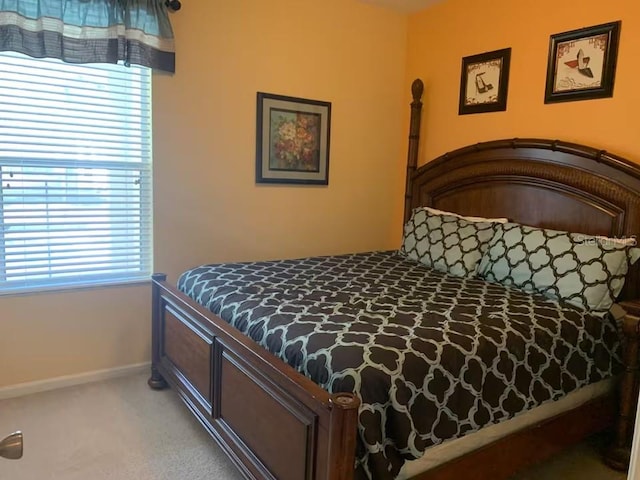 7763 Tosteth St, Kissimmee, FL 34747 - bedroom with light carpet and multiple windows