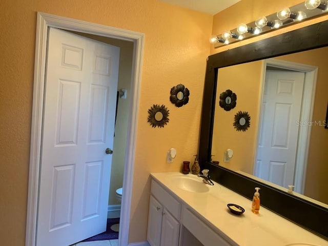 7763 Tosteth St, Kissimmee, FL 34747 - bathroom featuring double vanity, tile patterned floors, and a textured wall