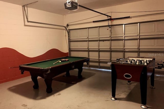 7763 Tosteth St, Kissimmee, FL 34747 - playroom with finished concrete flooring, billiards, and concrete block wall