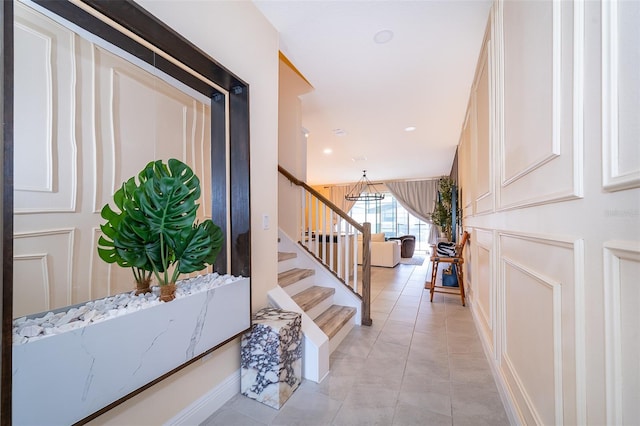 1660 Tropical Palms Cir, Kissimmee, FL 34747 - entryway featuring stairs, light tile patterned floors, and a chandelier