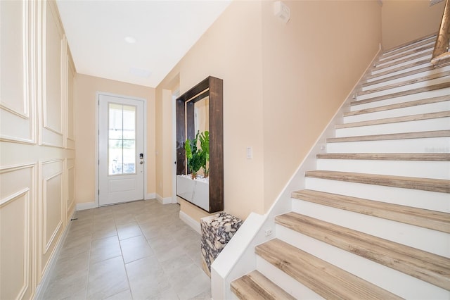 1660 Tropical Palms Cir, Kissimmee, FL 34747 - foyer entrance featuring stairs and light tile patterned floors