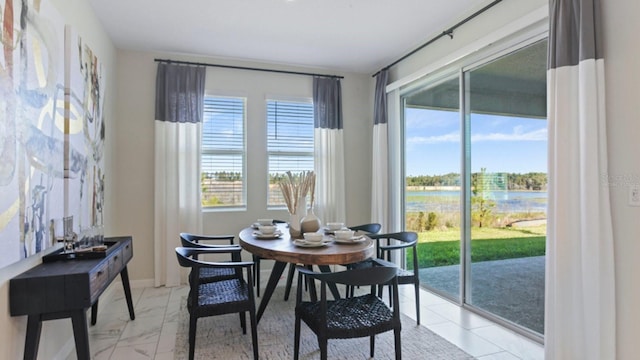 2347 Rider Rain Ln, Apopka, FL 32703 - dining space featuring a water view and light marble finish floors