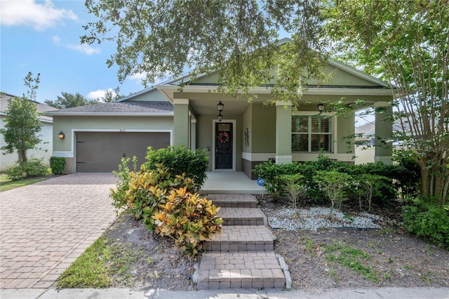 8827 Arrabida Ln, Orlando, FL 32836 - view of front of home featuring a porch, stucco siding, a garage, and decorative driveway