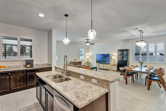 8827 Arrabida Ln, Orlando, FL 32836 - kitchen featuring stainless steel dishwasher, ceiling fan, light stone countertops, a textured ceiling, and open floor plan