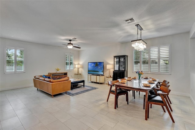 8827 Arrabida Ln, Orlando, FL 32836 - dining room featuring a chandelier and a ceiling fan