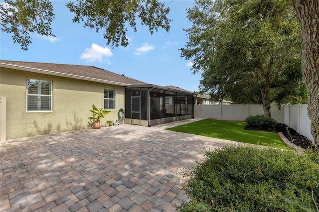 8827 Arrabida Ln, Orlando, FL 32836 - rear view of property with a sunroom, stucco siding, a fenced backyard, and a patio