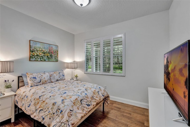 8827 Arrabida Ln, Orlando, FL 32836 - bedroom featuring wood finished floors and a textured ceiling