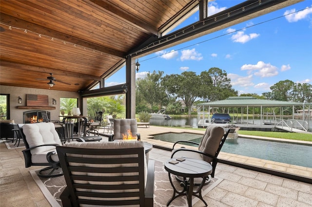 9070 Ron Den Ln, Windermere, FL 34786 - view of patio / terrace with a water view, an outdoor living space with a fireplace, an outdoor pool, and ceiling fan