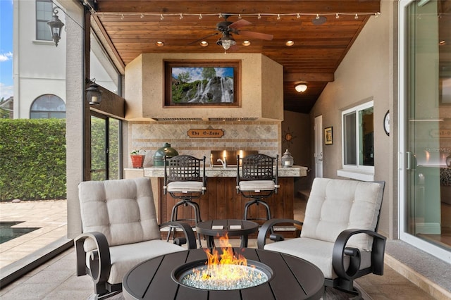 9070 Ron Den Ln, Windermere, FL 34786 - view of patio featuring an outdoor fire pit, ceiling fan, and a bar
