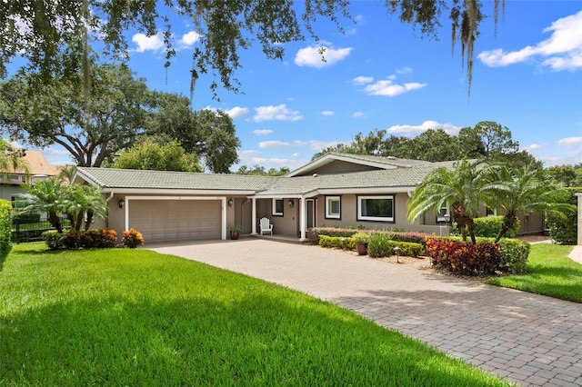 9070 Ron Den Ln, Windermere, FL 34786 - ranch-style house featuring a tile roof, a garage, driveway, and a front yard