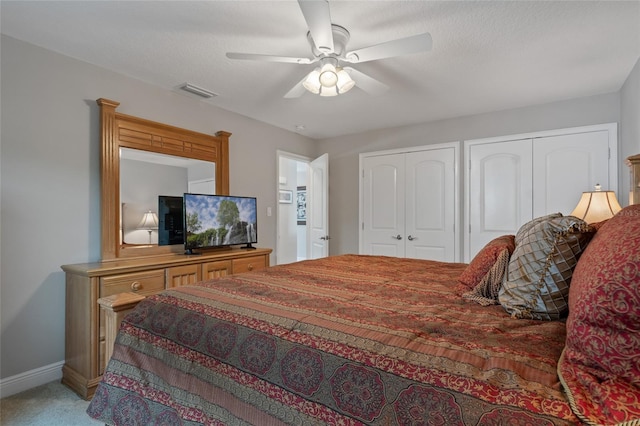 9070 Ron Den Ln, Windermere, FL 34786 - bedroom featuring multiple closets, light carpet, and a ceiling fan