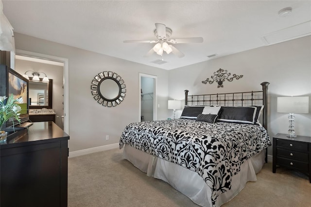 9070 Ron Den Ln, Windermere, FL 34786 - carpeted bedroom with a walk in closet, a ceiling fan, attic access, and ensuite bath