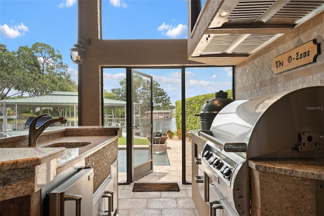 9070 Ron Den Ln, Windermere, FL 34786 - view of patio featuring exterior kitchen, a water view, and beverage cooler