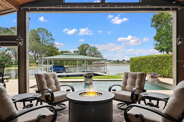 9070 Ron Den Ln, Windermere, FL 34786 - view of patio / terrace featuring a fire pit, a water view, boat lift, and a dock
