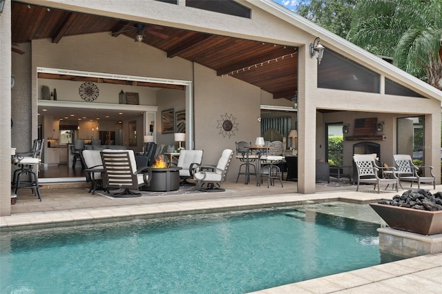 9070 Ron Den Ln, Windermere, FL 34786 - swimming pool featuring a patio area, a fire pit, an outdoor fireplace, and ceiling fan