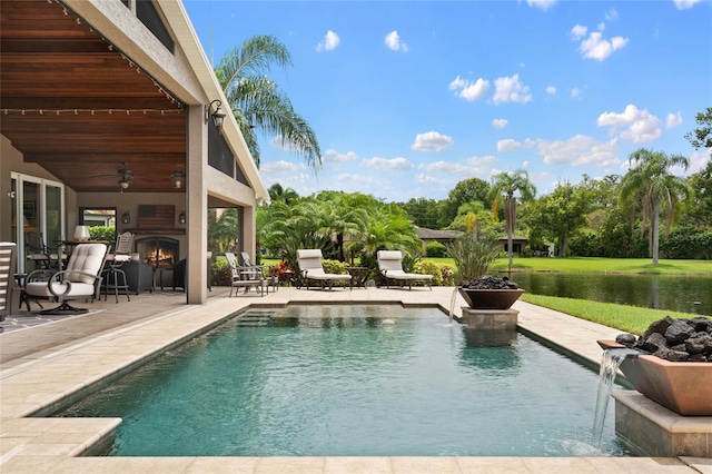 9070 Ron Den Ln, Windermere, FL 34786 - outdoor pool with a patio, ceiling fan, a warm lit fireplace, and a water view