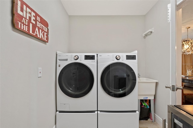 9070 Ron Den Ln, Windermere, FL 34786 - laundry room with washing machine and dryer, light wood-style flooring, and wine cooler