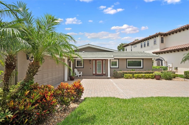 9070 Ron Den Ln, Windermere, FL 34786 - view of front of home featuring a garage, stucco siding, and a tiled roof