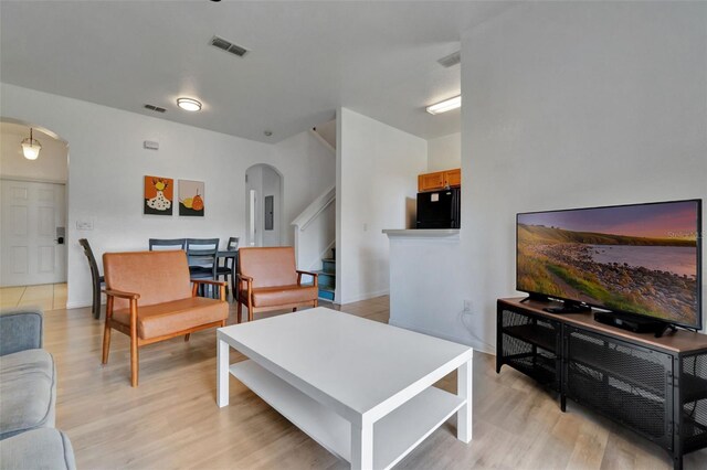 216 Bergamo Dr, Davenport, FL 33897 - living room with arched walkways, light wood-type flooring, and stairs