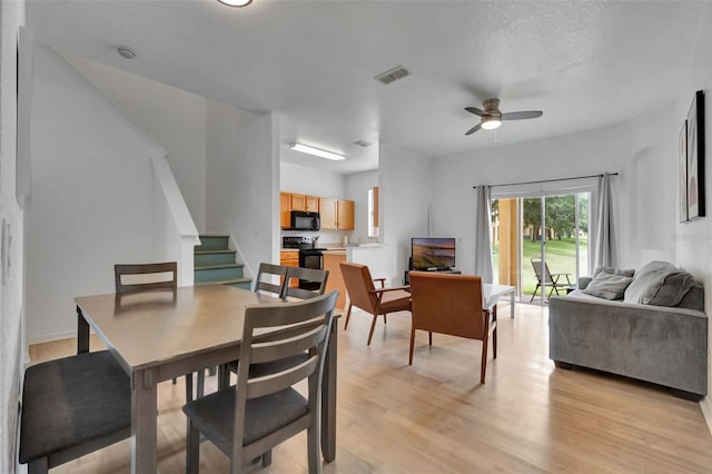216 Bergamo Dr, Davenport, FL 33897 - dining room featuring stairs, a ceiling fan, and light wood-style flooring
