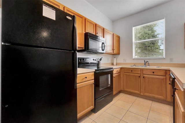 216 Bergamo Dr, Davenport, FL 33897 - kitchen with black appliances, light tile patterned floors, and light countertops