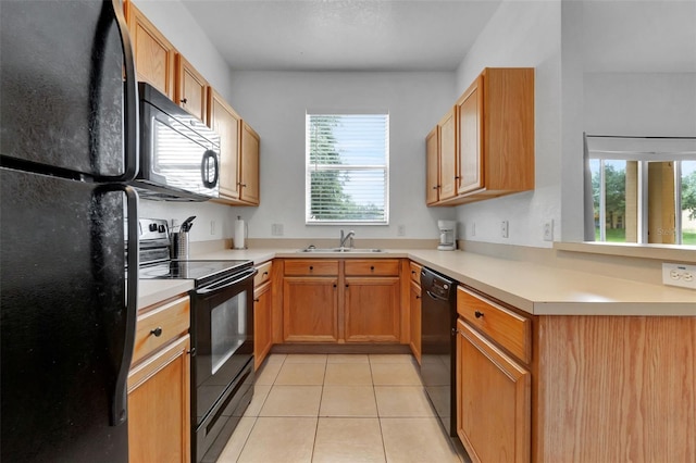 216 Bergamo Dr, Davenport, FL 33897 - kitchen featuring black appliances, light tile patterned floors, and light countertops