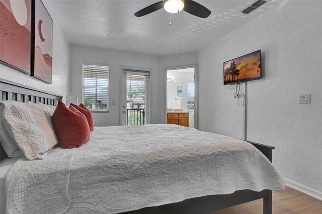 216 Bergamo Dr, Davenport, FL 33897 - bedroom featuring wood finished floors, access to exterior, connected bathroom, a ceiling fan, and a textured wall