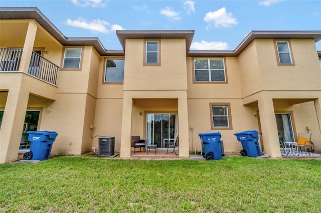 216 Bergamo Dr, Davenport, FL 33897 - back of property featuring a patio, stucco siding, and a lawn