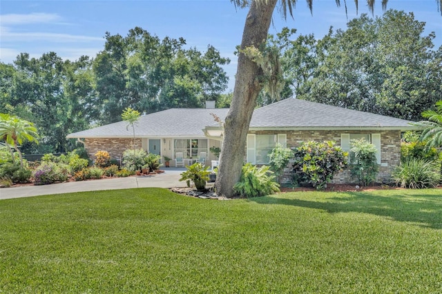 1238 Palmetto Rd, Eustis, FL 32726 - single story home with a front yard, concrete driveway, brick siding, and a shingled roof