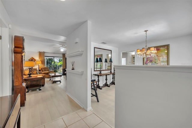 1238 Palmetto Rd, Eustis, FL 32726 - hallway with a chandelier and light wood-type flooring