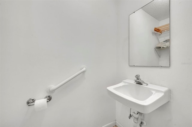 1238 Palmetto Rd, Eustis, FL 32726 - bathroom featuring a textured ceiling and baseboards