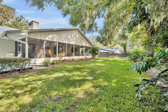 1238 Palmetto Rd, Eustis, FL 32726 - rear view of property featuring a sunroom and a chimney