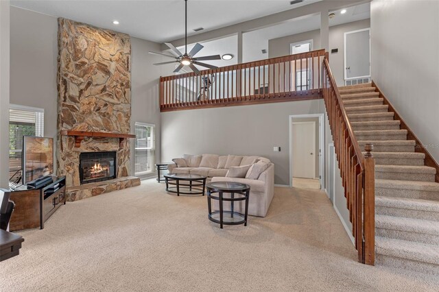 1041 Mccully Ct, Oviedo, FL 32765 - carpeted living area with a high ceiling, a ceiling fan, a fireplace, stairs, and recessed lighting