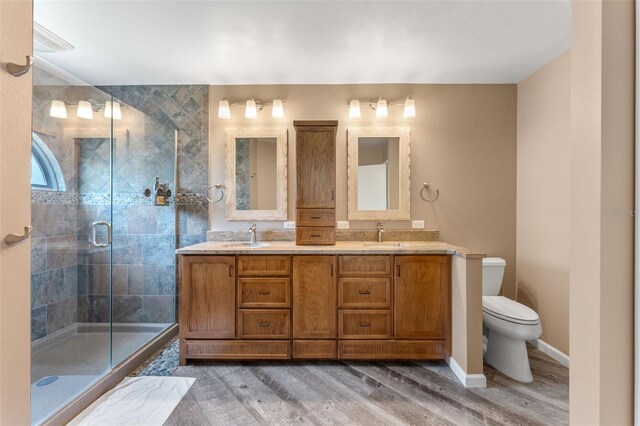 1041 Mccully Ct, Oviedo, FL 32765 - full bathroom featuring double vanity, a shower stall, and wood finished floors