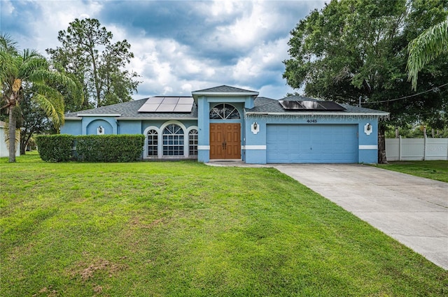 4045 Simkins Ave, North Port, FL 34286 - view of front of house with stucco siding, roof mounted solar panels, a garage, and driveway
