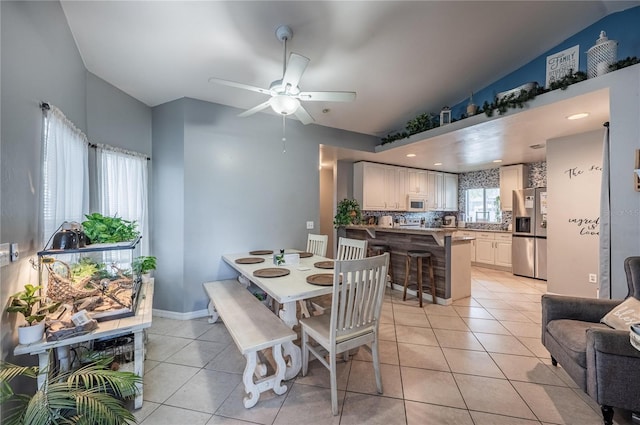 4045 Simkins Ave, North Port, FL 34286 - dining room featuring light tile patterned floors, vaulted ceiling, and ceiling fan