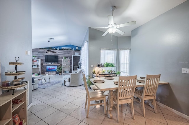 4045 Simkins Ave, North Port, FL 34286 - dining room with a ceiling fan, lofted ceiling, light tile patterned floors, and a tile fireplace
