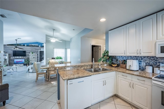 4045 Simkins Ave, North Port, FL 34286 - kitchen with white appliances, ceiling fan, vaulted ceiling, a peninsula, and light tile patterned floors