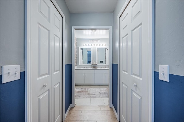 4045 Simkins Ave, North Port, FL 34286 - bathroom with double vanity, a closet, and wood finished floors