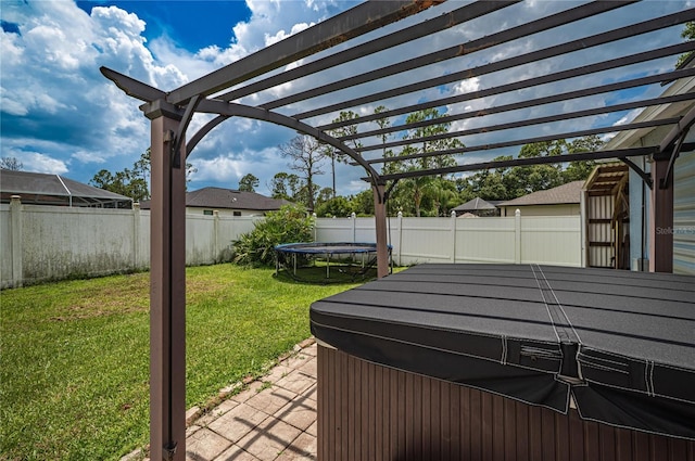 4045 Simkins Ave, North Port, FL 34286 - fenced backyard with a trampoline, a hot tub, a pergola, and a patio area