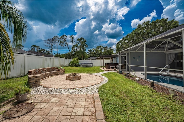 4045 Simkins Ave, North Port, FL 34286 - fenced backyard with an outdoor fire pit, a patio, a hot tub, and a lanai