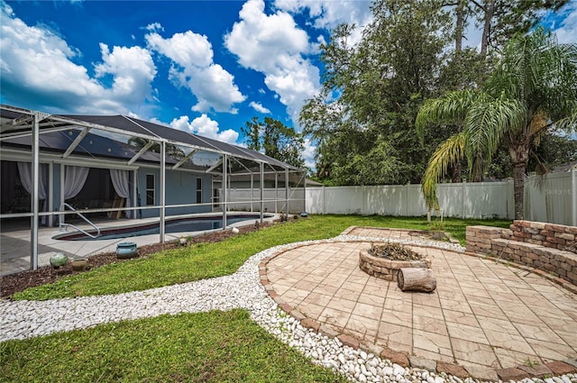 4045 Simkins Ave, North Port, FL 34286 - fenced backyard with an outdoor fire pit, a patio, and glass enclosure