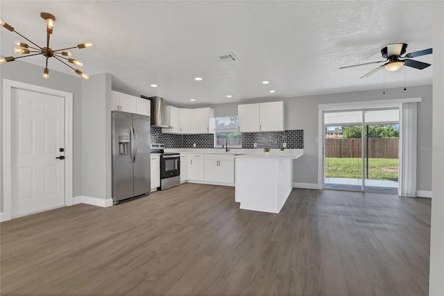 5904 Altec Rd, Orlando, FL 32808 - kitchen featuring appliances with stainless steel finishes, wall chimney range hood, light countertops, backsplash, and plenty of natural light