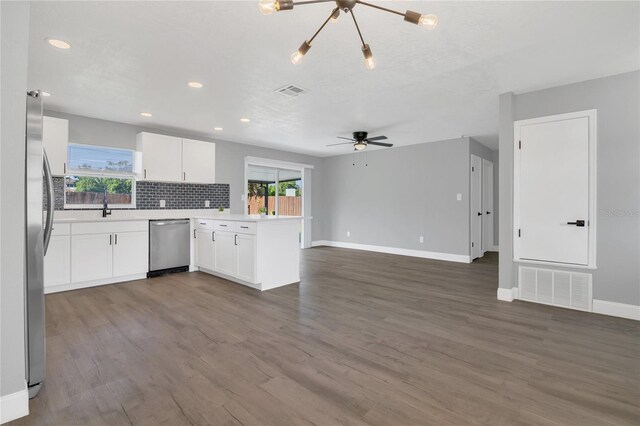 5904 Altec Rd, Orlando, FL 32808 - kitchen with appliances with stainless steel finishes, a peninsula, open floor plan, a ceiling fan, and white cabinets