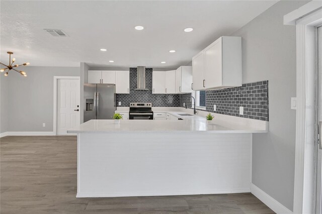 5904 Altec Rd, Orlando, FL 32808 - kitchen with appliances with stainless steel finishes, light countertops, wall chimney range hood, backsplash, and recessed lighting