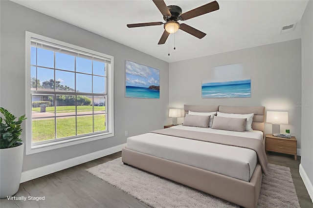 5904 Altec Rd, Orlando, FL 32808 - bedroom featuring multiple windows, wood finished floors, and ceiling fan