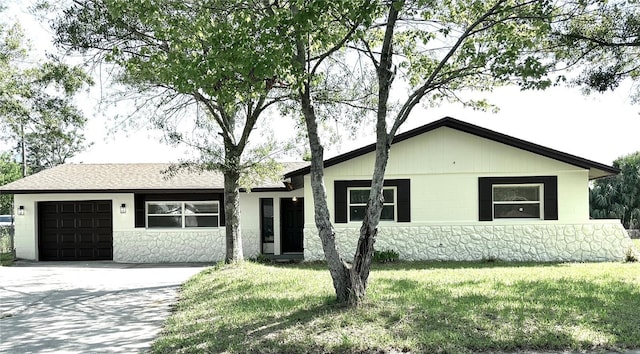 4219 Chateau Rd, Orlando, FL 32808 - single story home with a garage, concrete driveway, a front lawn, and stone siding