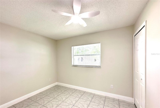 4219 Chateau Rd, Orlando, FL 32808 - unfurnished bedroom featuring a textured ceiling, a closet, ceiling fan, and light marble finish flooring